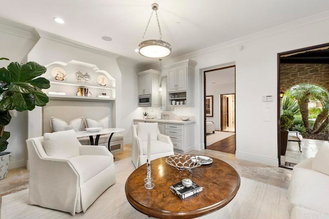 living room featuring light hardwood / wood-style flooring and crown molding