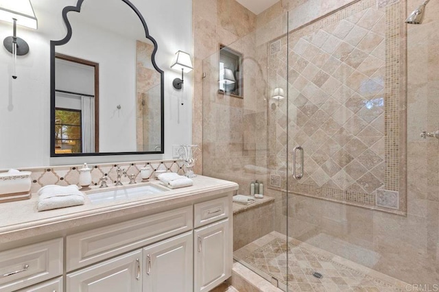 bathroom with vanity and a shower with door