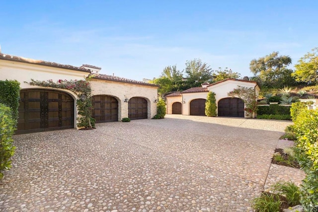 mediterranean / spanish house featuring a garage