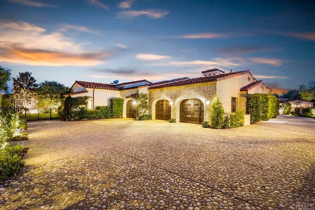 mediterranean / spanish-style house with a garage