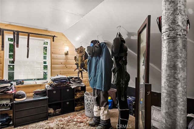 walk in closet featuring vaulted ceiling and carpet