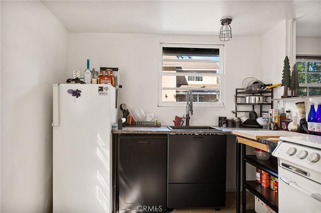 kitchen featuring tile patterned flooring, sink, and white refrigerator