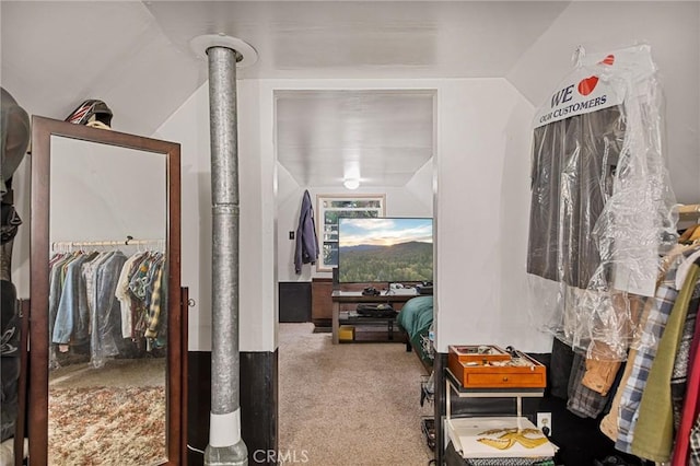 interior space featuring lofted ceiling and carpet floors