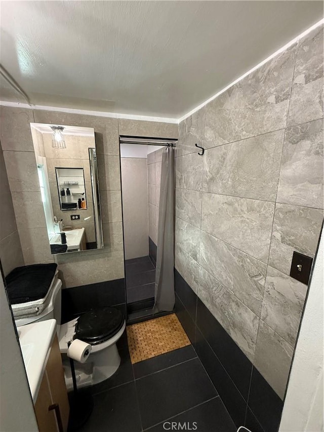 bathroom with tile walls, walk in shower, and tile patterned flooring