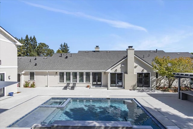 view of swimming pool featuring a patio area and an in ground hot tub