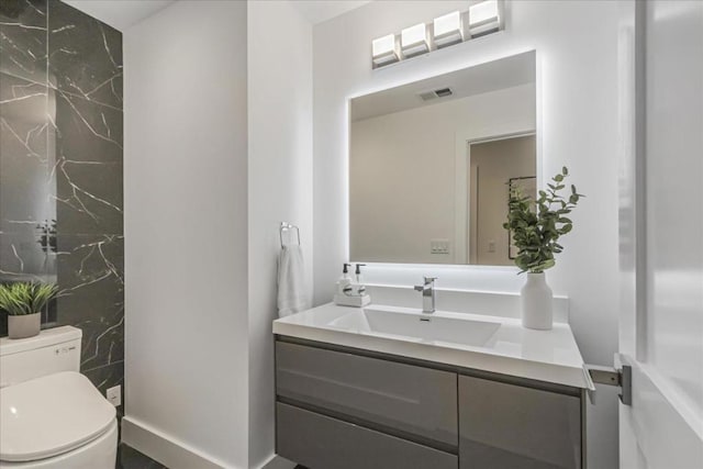 bathroom with toilet and vanity