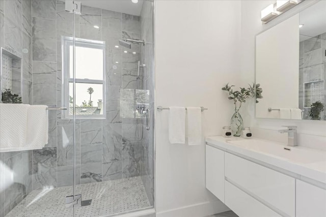 bathroom featuring an enclosed shower and vanity