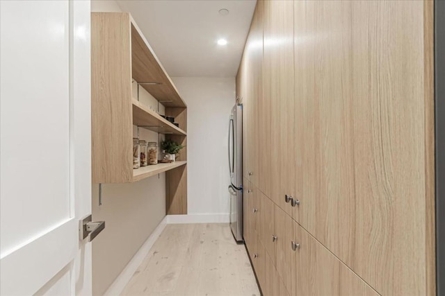 corridor with light hardwood / wood-style flooring