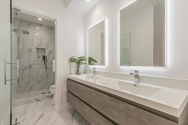 bathroom with toilet, vanity, and an enclosed shower