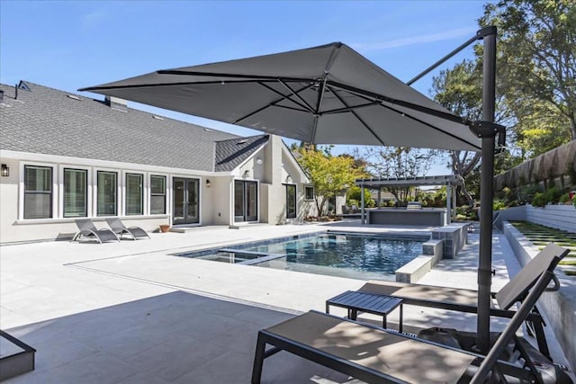 view of swimming pool with an in ground hot tub and a patio