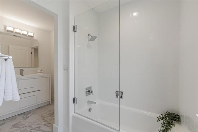 bathroom with combined bath / shower with glass door and vanity