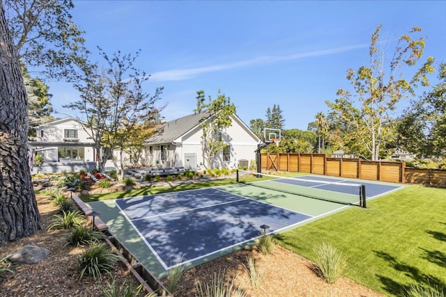 exterior space featuring a yard and basketball hoop