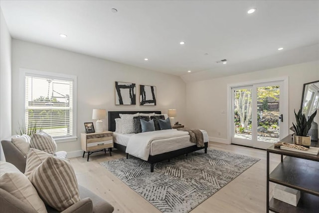 bedroom featuring light wood-type flooring and access to outside