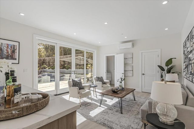 living room with an AC wall unit, french doors, and light hardwood / wood-style floors