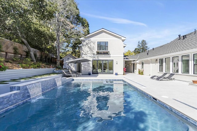 view of swimming pool with pool water feature