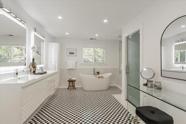 bathroom featuring vanity and shower with separate bathtub