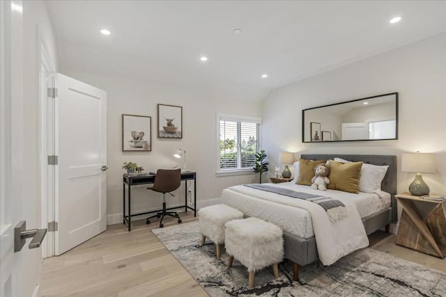 bedroom with vaulted ceiling and light hardwood / wood-style floors