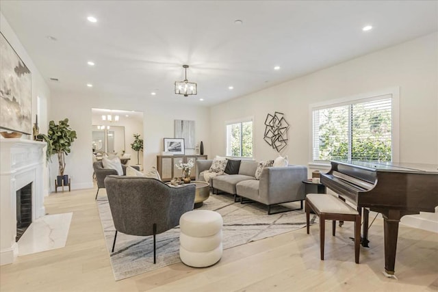 living room with light hardwood / wood-style flooring and a notable chandelier