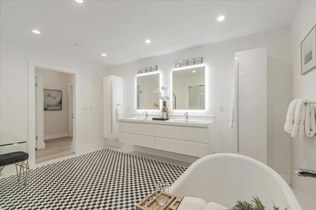 bathroom featuring a tub to relax in and vanity