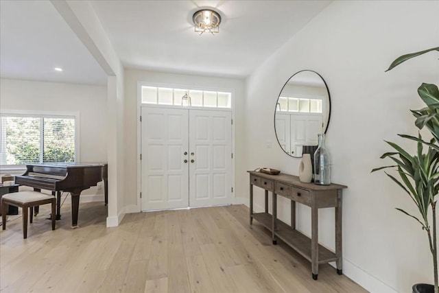 foyer entrance with light hardwood / wood-style floors