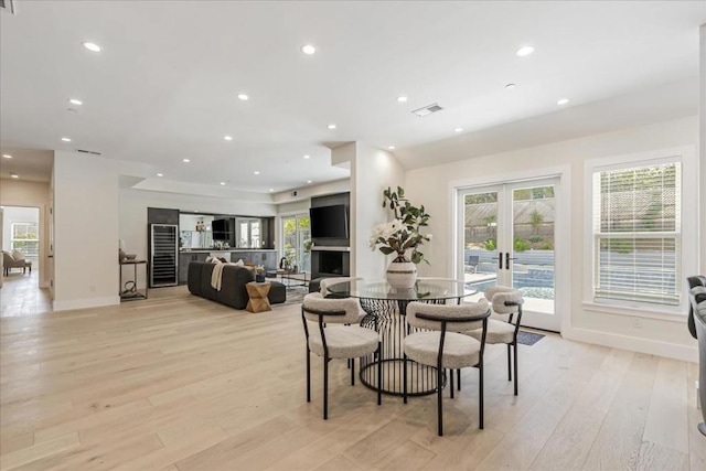 dining room with light hardwood / wood-style flooring and french doors