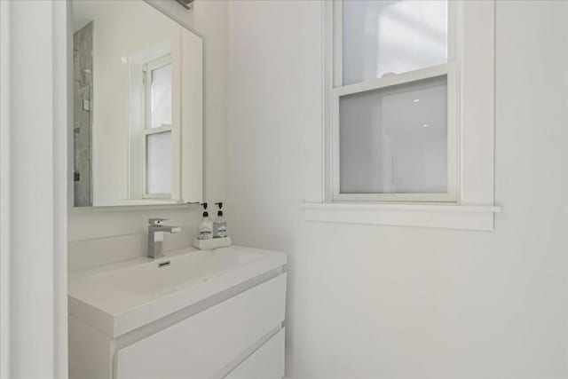 bathroom featuring a healthy amount of sunlight and vanity