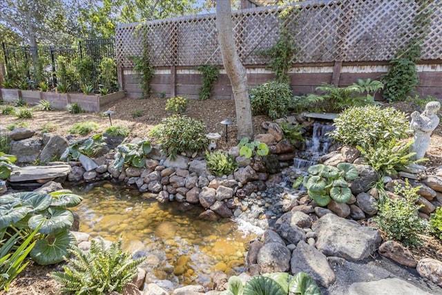 view of yard with a garden pond