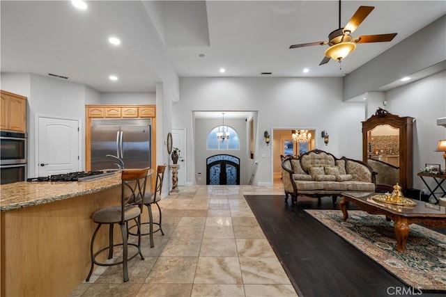 living room with a ceiling fan and recessed lighting