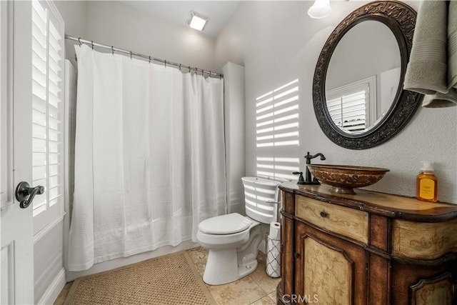bathroom with vanity, tile patterned flooring, and toilet