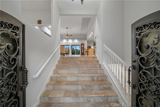 entryway featuring stairway and ceiling fan