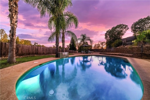 pool at dusk featuring a gazebo, a fenced in pool, and a fenced backyard
