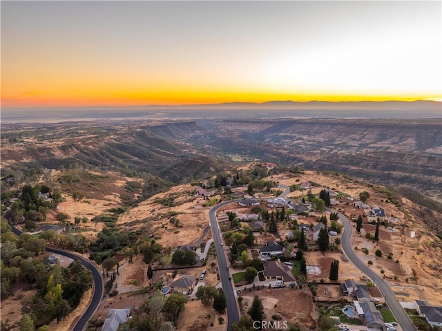 birds eye view of property with a mountain view