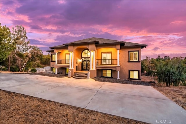 view of front of property with a balcony and stucco siding