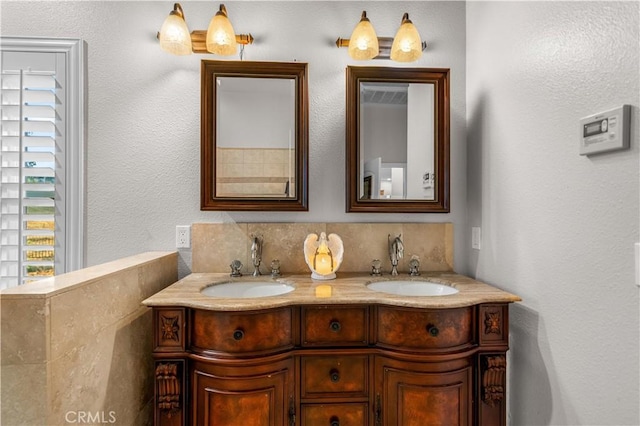 bathroom featuring a sink and double vanity