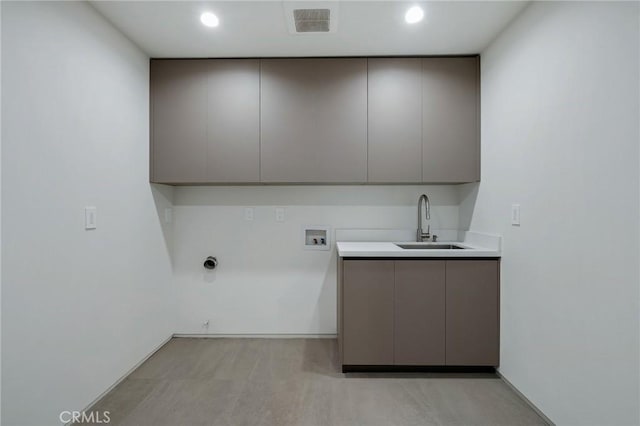 laundry area featuring sink, cabinets, and washer hookup