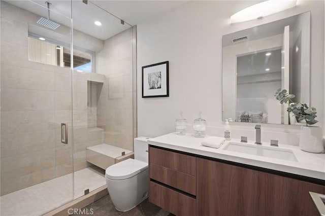 bathroom with tile patterned floors, vanity, toilet, and walk in shower