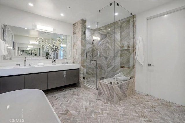 bathroom with vanity and independent shower and bath