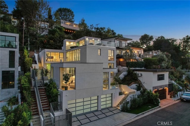 contemporary home featuring a balcony and a garage