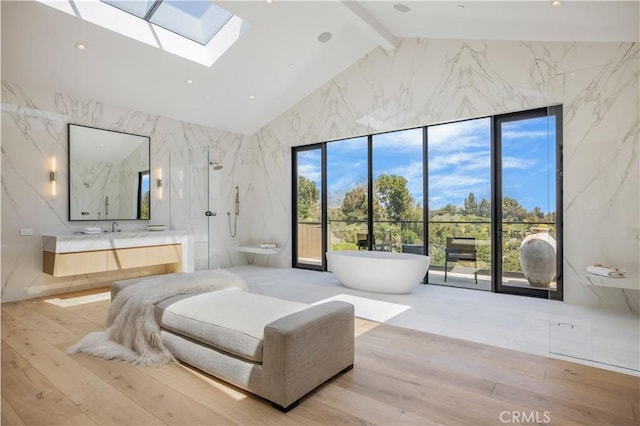 bedroom featuring access to exterior, a skylight, hardwood / wood-style flooring, high vaulted ceiling, and beamed ceiling