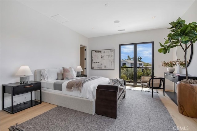 bedroom featuring hardwood / wood-style floors and access to outside