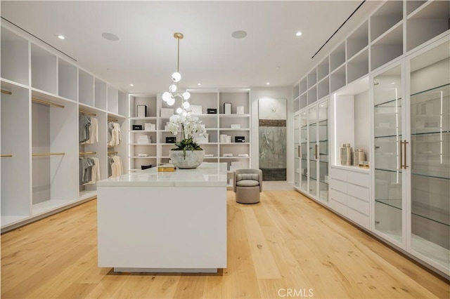 kitchen featuring decorative light fixtures and light hardwood / wood-style floors