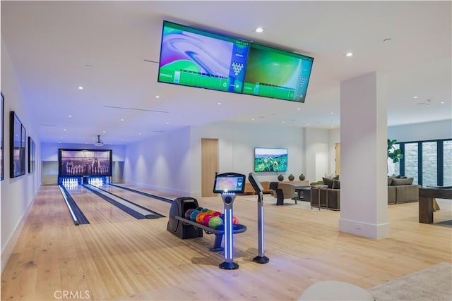 rec room with a bowling alley and light hardwood / wood-style floors