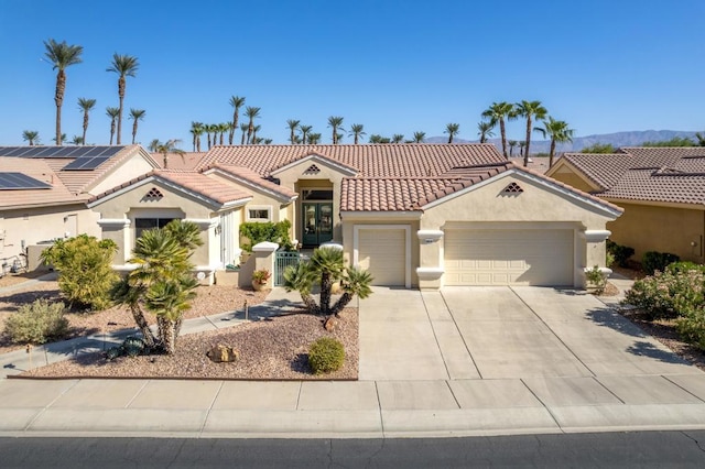 mediterranean / spanish-style home with a garage