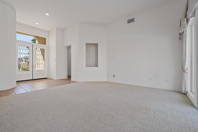 carpeted foyer entrance featuring french doors