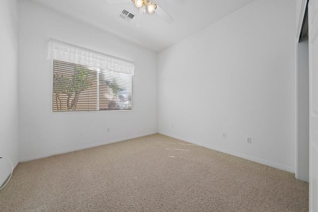 carpeted spare room featuring ceiling fan