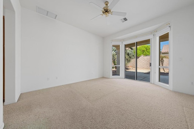 carpeted spare room with ceiling fan