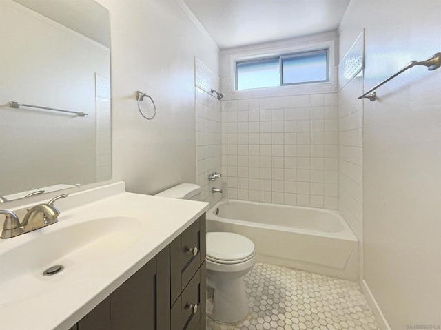 full bathroom with vanity, tiled shower / bath combo, crown molding, tile patterned flooring, and toilet