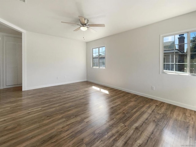 spare room featuring ceiling fan and dark wood-type flooring