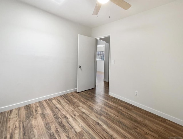 empty room featuring ceiling fan and dark hardwood / wood-style floors