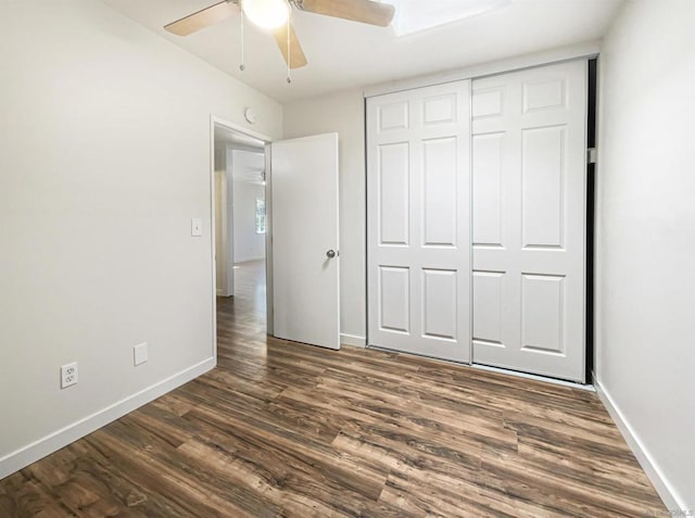 unfurnished bedroom featuring dark hardwood / wood-style flooring, a closet, and ceiling fan